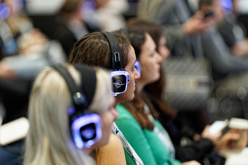 Audience wearing Silent Seminar headphones at an on-site event